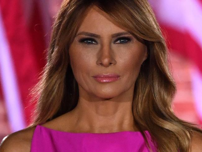 TOPSHOT - US First Lady Melania Trump and US President Donald Trump listen to the US National Anthem, "The Star-Spangled Banner", during the third night of the Republican National Convention at Fort McHenry National Monument in Baltimore, Maryland, August 26, 2020. (Photo by SAUL LOEB / AFP)