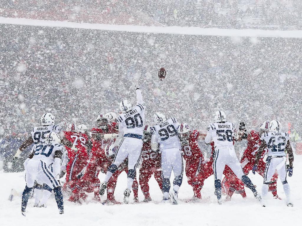 Snow covered Colts vs. Bills game action photos