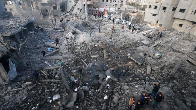 Palestinians stand amid the rubble of buildings destroyed in Israeli bombardment in Rafah in the southern Gaza Strip on Thursday. Picture: AFP