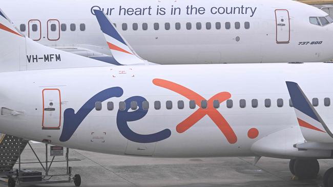 Rex Airlines Boeing 737 planes lay idle on the tarmac at Melbourne's Tullamarine Airport on July 31, 2024. The Australian regional airline Rex cancelled flights as it entered voluntary administration on July 31, leaving the fate of the country's third-largest carrier in serious doubt. (Photo by William WEST / AFP)