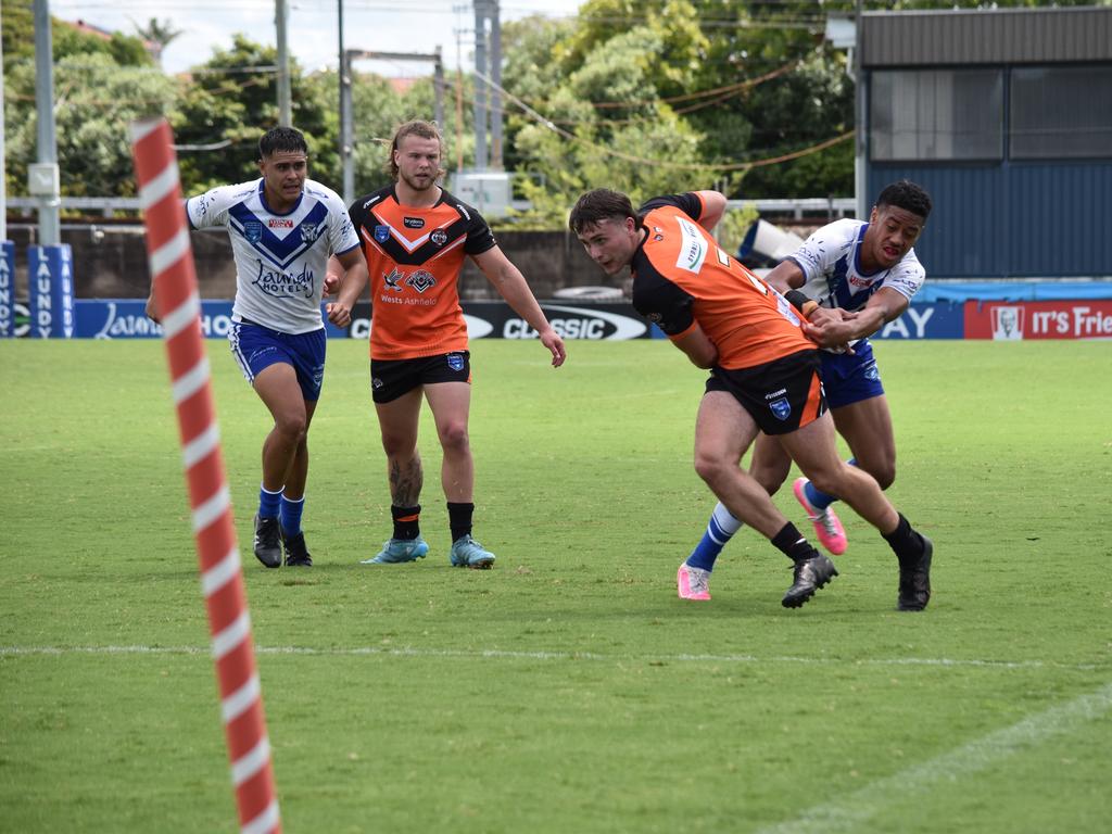 William Malloy is tackled by Jonathan Sua. Picture: Sean Teuma/NewsLocal