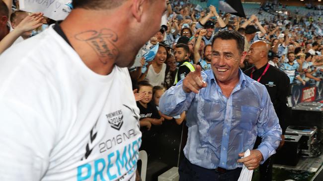 Shark's coach Shane Flanagan sees the funny side after having the contents of an Esky tipped over his head at ANZ Stadium.