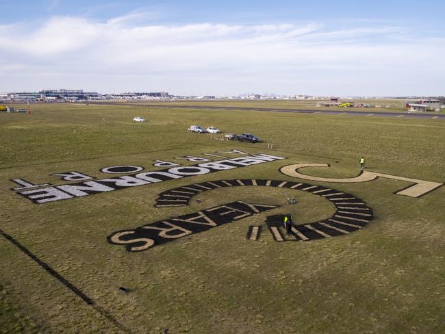 A giant image marking its 50-year anniversary is constructed at Melbourne Airport.