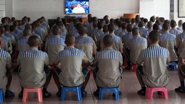 Prisoners watch TV at a prison in Shenzhen city in south China's Guangdong province, 8 May 2014.