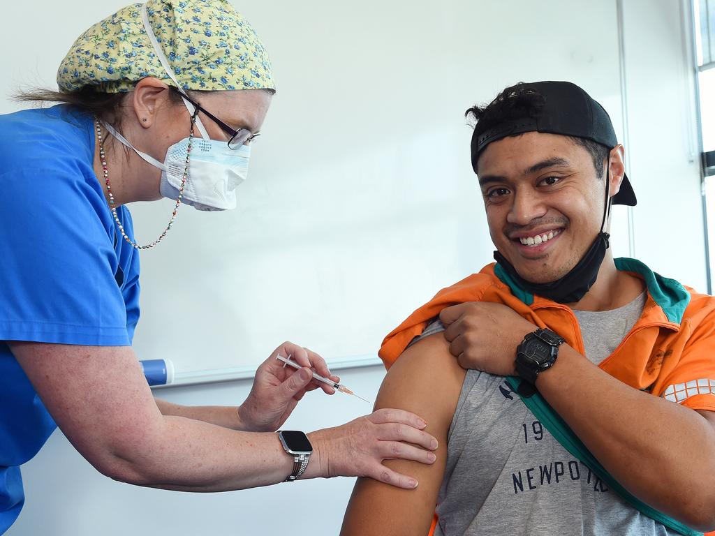 Toll Group have made would COVID-19 vaccines available at key sites across Melbourne over the coming weeks. (L-R) Nurse Karena Watson and Toll worker Jonathan Toetu getting a vaccine at the KMART distribution centre in Truganina, operated by TOLL. Picture: Josie Hayden