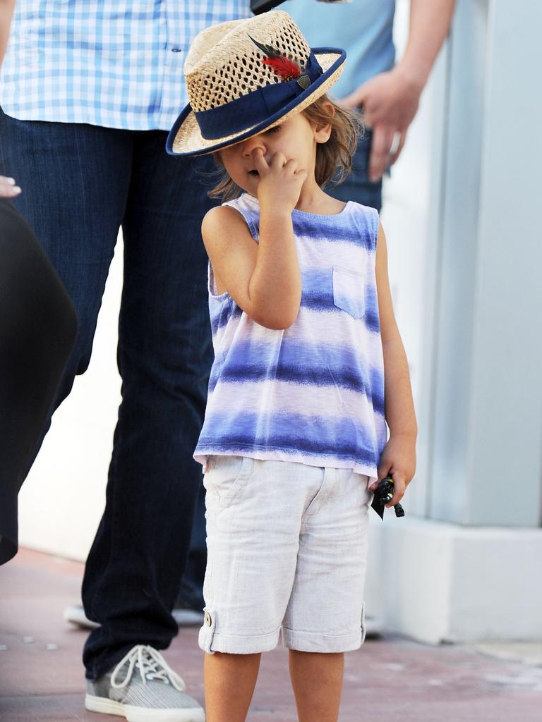 Still cute ... Stylish Mason Disick digs for gold while out shopping with mum Kourtney Kardashian and dad Scott Disick. Picture: Australscope