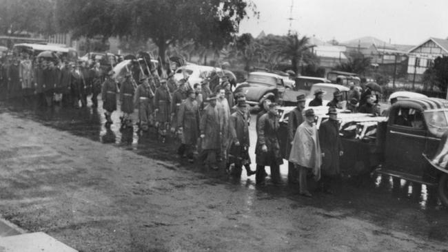 Funeral procession for the Monto air crash victims, 1948. The community gathers to honour the lives lost in this tragic accident. Source: John Oxley Library, State Library of Queensland