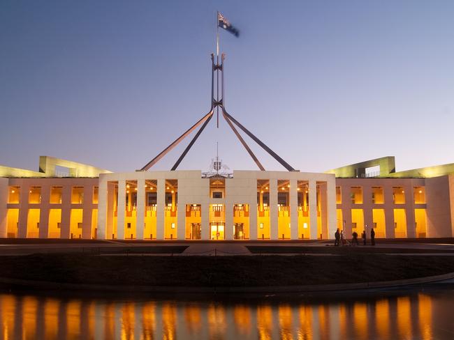 Parliament House in Canberra, Australia, illuminated at dusk.