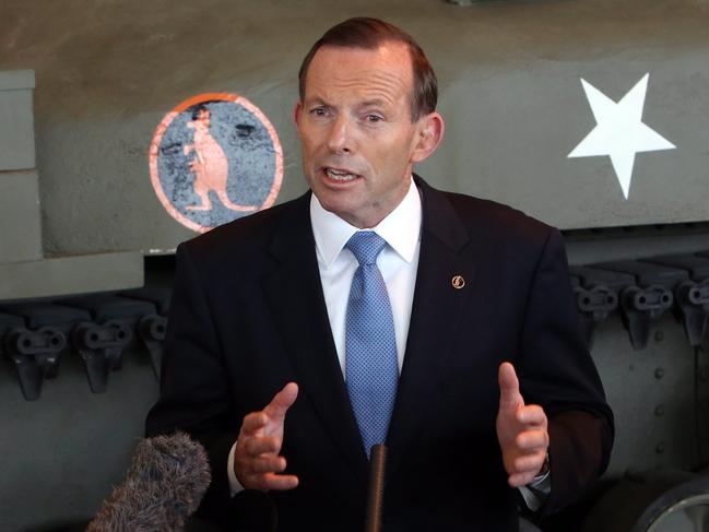 Australian Prime Minister Tony Abbott talks to reporters standing in front of a Kangaroo armored personnel carrier at the Canadian War Museum in Ottawa, Sunday, June 8, 2014. (AP Photo/The Canadian Press, Fred Chartrand)
