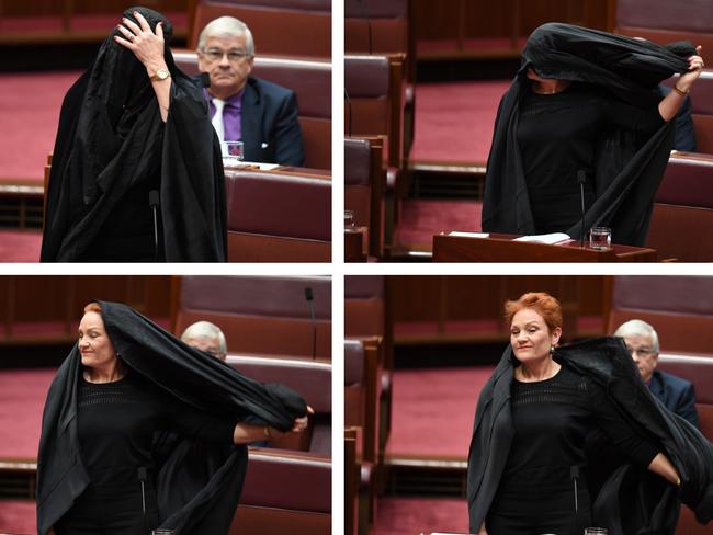 One Nation Senator Pauline Hanson taking off a burqa during Senate Question Time at Parliament House in Canberra. Picture: AAP