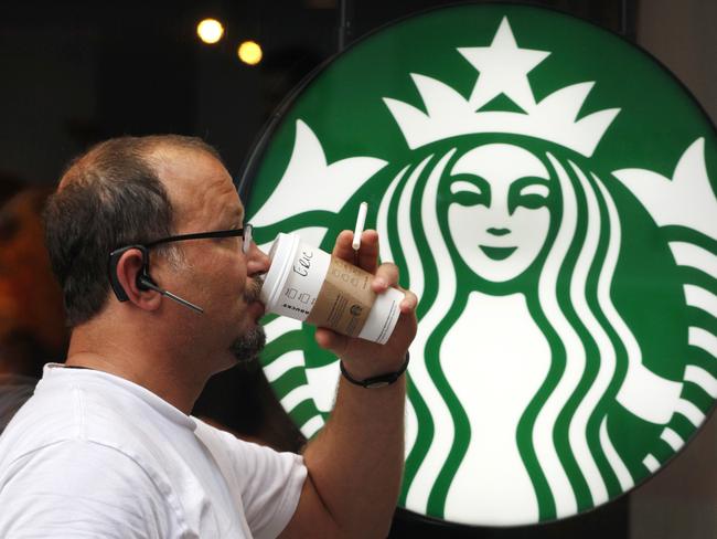 FILE - In this July 11, 2013 file photo, a man drinks a Starbucks coffee in New York. Starbucks says it’s hiking prices again starting Tuesday, July 7, 2015, with the increases ranging from 5 to 20 cents for most affected drinks. (AP Photo/Mark Lennihan, File)