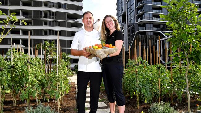 Chef Neven Vanderzee and food and beverage manager Corryn Rattray with some of the food and one of the chickens from the edible garden. Picture: John Gass