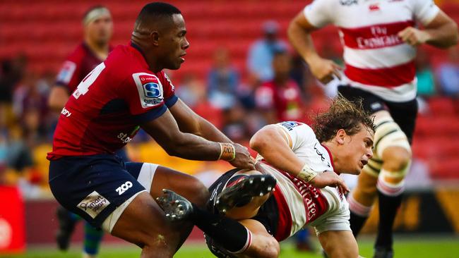 Reds' Filipo Daugunu and Lions' Andries Coetzee compete for the ball.