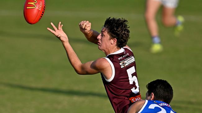 Harrison Hanley fires off a handball for Melton. Picture: Andy Brownbill