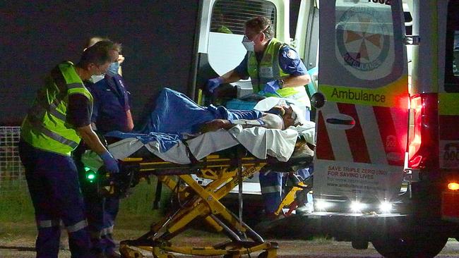 Paramedics treat a man at the scene of a two-car crash in Bent Street, South Grafton, on Saturday. Picture: Frank Redward