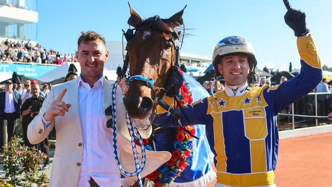 Swayzee's trainer Jason Grimson (left) and driver Cameron Hart celebrate the champ's NZ Cup win. Picture: HRNZ