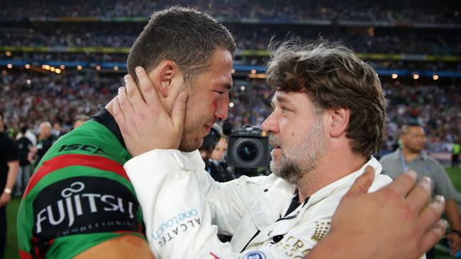 Souths co-owner Russell Crowe embraces Sam Burgess after the Rabbitohs won the 2014 NRL grand final. Picture Gregg Porteous