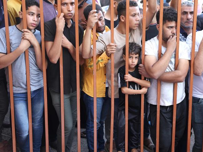 Palestinians wait to collect the bodies of their relatives outside the Nasser hospital, killed in Israeli strikes, in Khan Yunis, in the southern Gaza Strip. Picture: AFP