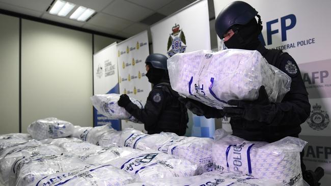 Australian Federal Police officer loads pseudoephedrine onto a table. Picture: AAP/Julian Smith