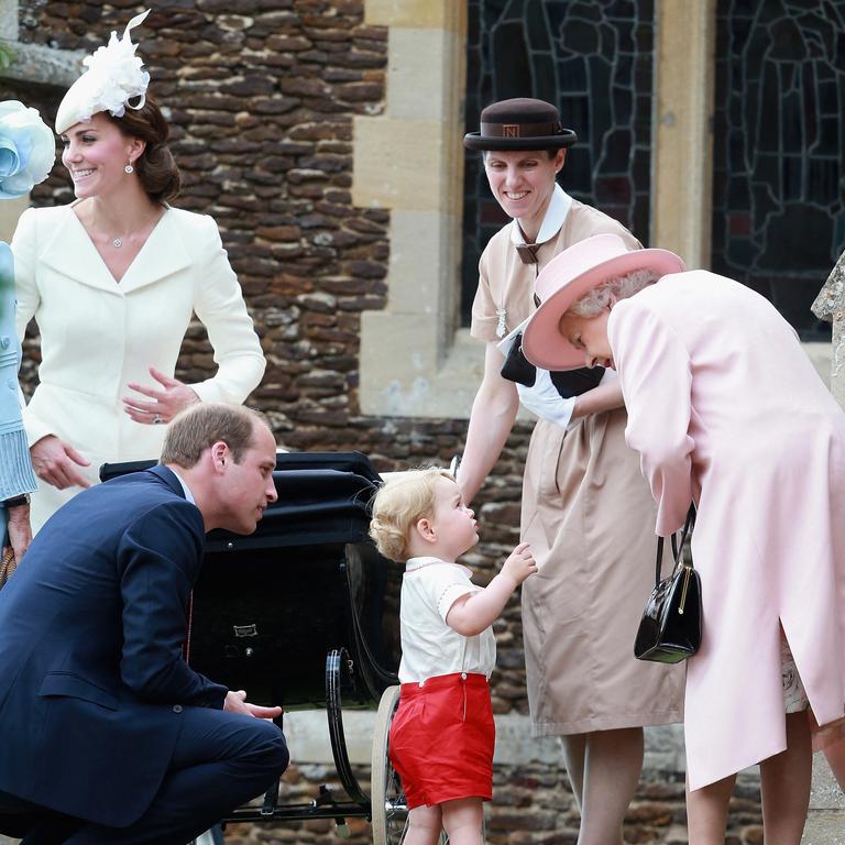 2015: Prince George speaks to his great grandmother the Queen as they leave Princess Charlotte’s christening at St Mary Magdalene Church in Sandringham. Picture: Chris Jackson/AFP