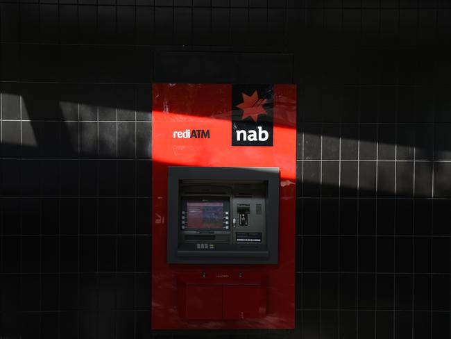 A shadow is cast over an automated teller machine (ATM) at a National Australia Bank Ltd. (NAB) branch in Melbourne, Australia, on Monday, May 2, 2016. National Australia is scheduled to report half-year results on May 5. Photographer: Carla Gottgens/Bloomberg via Getty Images