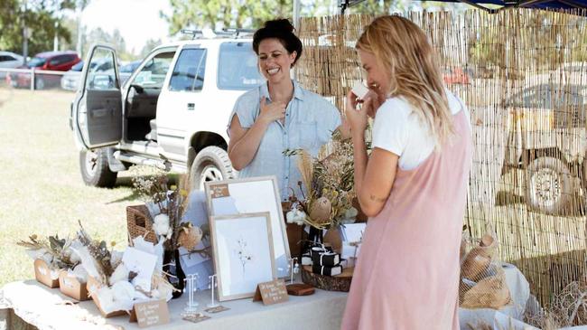 HANDMADE LOVE: Katie May from Wylde Magnolia and an interested customer at a past Sunshine Coast Collective Market. Picture: Contributed