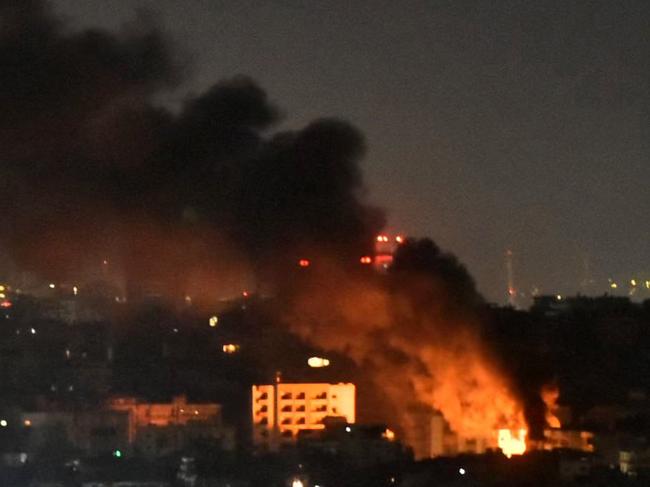 Smoke and flames rise from areas targeted by an Israeli airstrike in Beirutâs southern suburbs late on October 20, 2024. (Photo by Fadel ITANI / AFP)