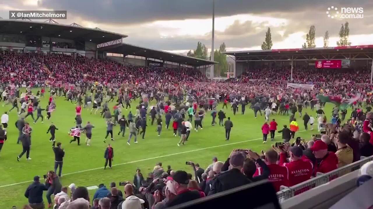 Fans storm field after Wrexham wins promotion