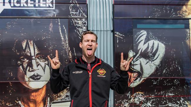 Supercars driver David Reynolds striking a KISS pose in-front of Newcastle's KISS tram