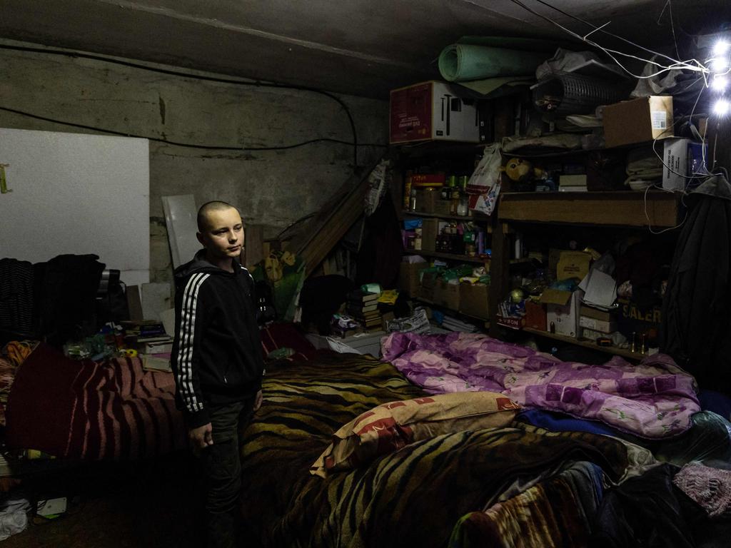 Gleb Petrov, 14-year-old, looks on as he sits with his family in a basement in the city of Bakhmut, eastern Ukraine. Picture: AFP