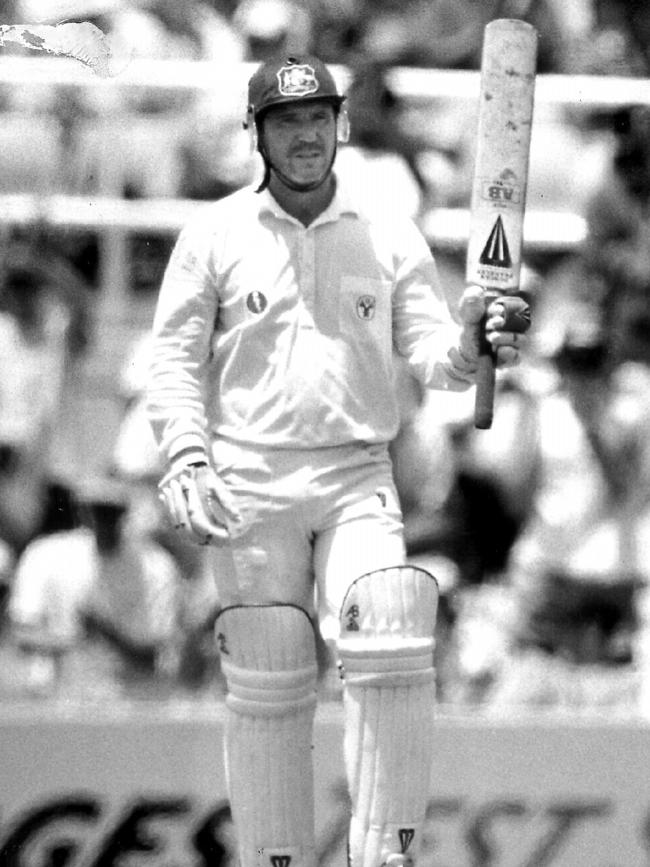 Allan Border raises his bat to the crowd after scoring his 10,000th run in Test cricket against the West Indies at the SCG. Picture: Gregg Porteous