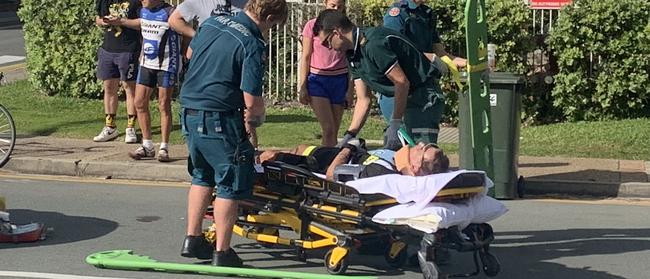 A person is treated by paramedics after a Suzuki car collided with a cyclist  at the corner of Garfield Terrace and Thornton St, beside the Northcliffe Surf Lifesaving Club, Surfers Paradise.