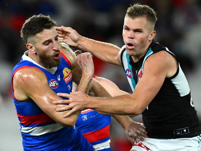 MELBOURNE, AUSTRALIA - JUNE 09: Marcus Bontempelli of the Bulldogs bumps Dan Houston of the Power during the round 13 AFL match between Western Bulldogs and Port Adelaide Power at Marvel Stadium, on June 09, 2023, in Melbourne, Australia. (Photo by Quinn Rooney/Getty Images)