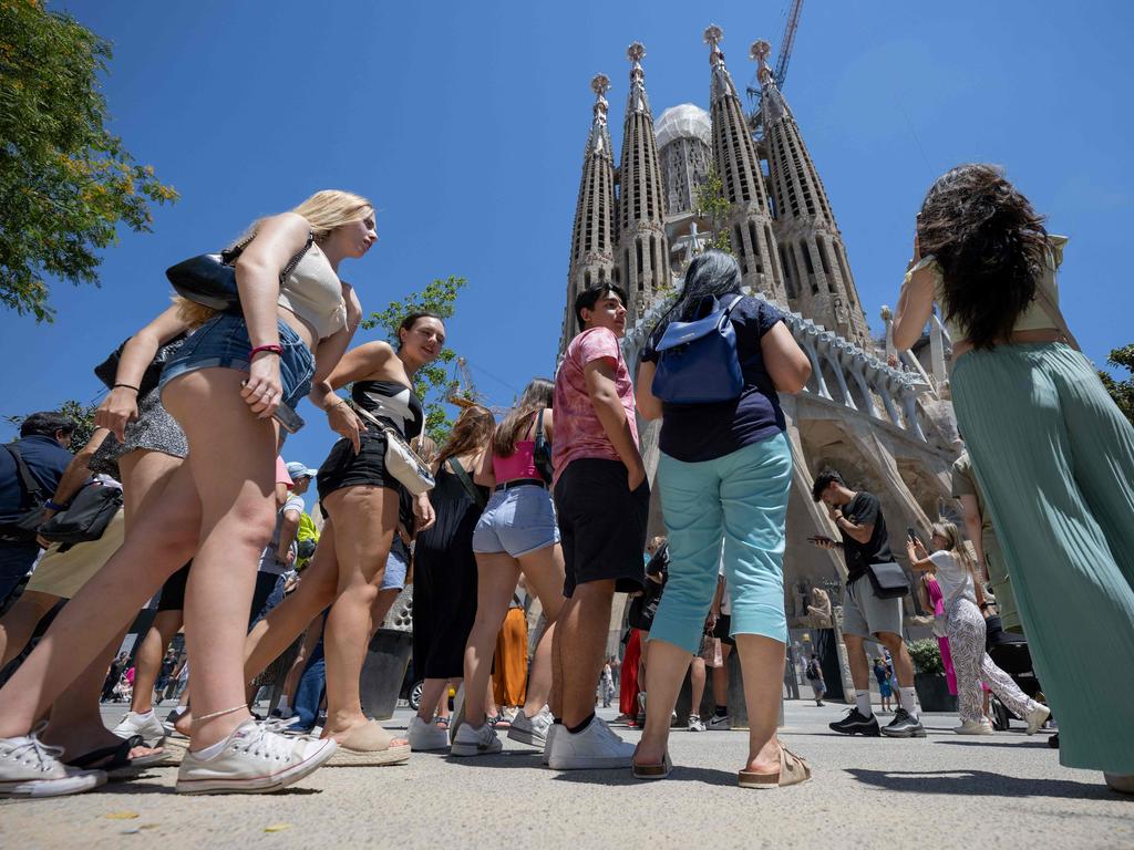 Tourists stand in front of the Sagrada Familia basilica in Barcelona. Picture: AFP