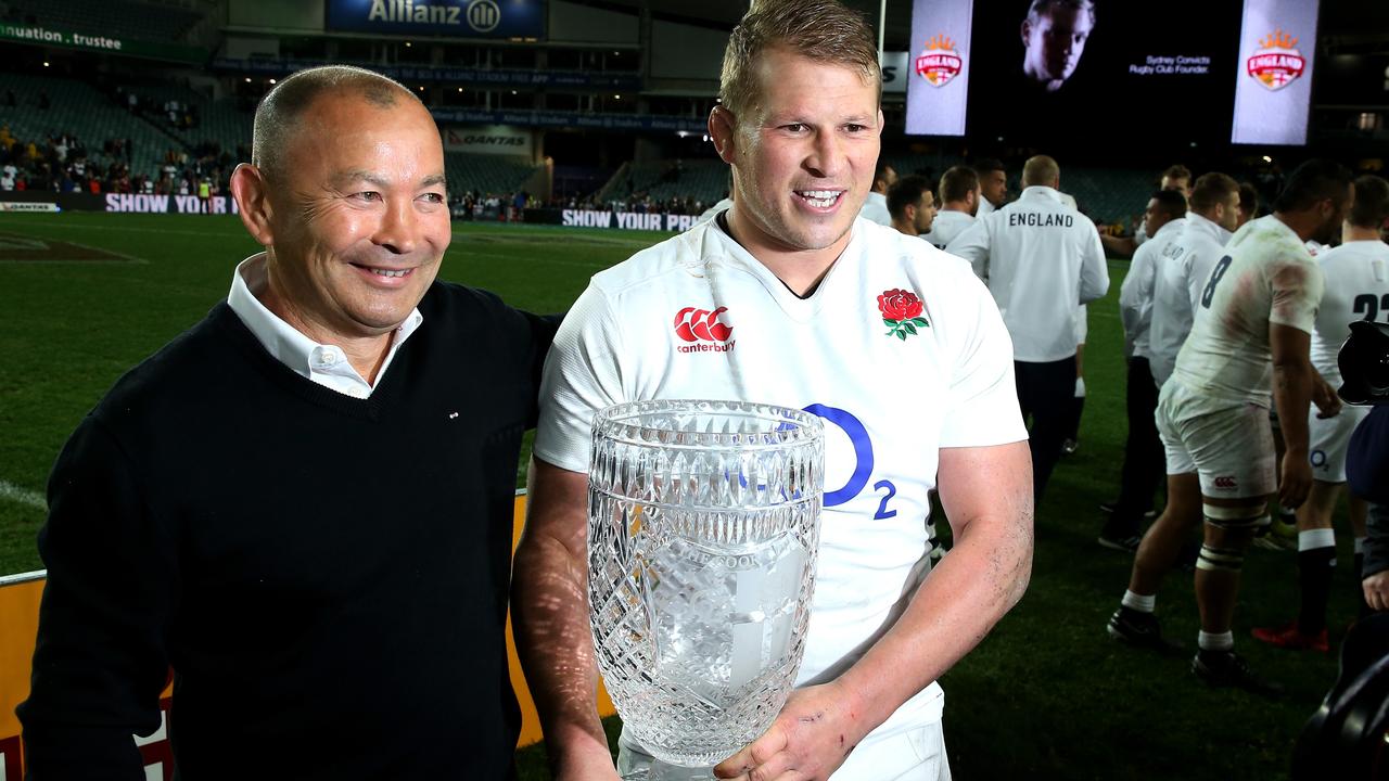 Dylan Hartley holds the Cook Cup with England head coach Eddie Jones in 2016.