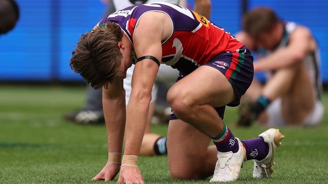 PERTH, AUSTRALIA - AUGUST 20: Aliir Aliir, Kane Farrell and Tom Jonas of the Power and Jye Amiss of the Dockers take a moment after a collision on the goal line during the round 23 AFL match between Fremantle Dockers and Port Adelaide Power at Optus Stadium, on August 20, 2023, in Perth, Australia. (Photo by Paul Kane/Getty Images)