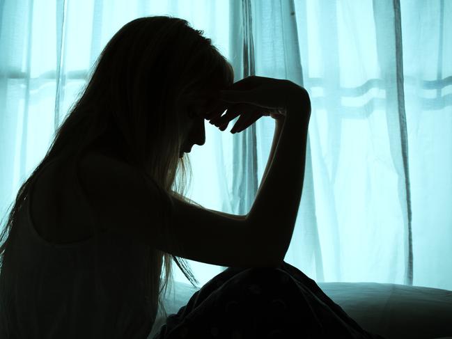 Silhouette of woman sitting in bed by window Picture: Istock