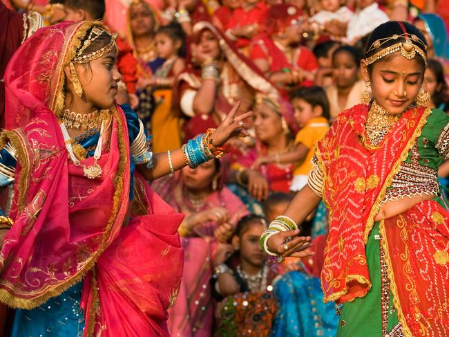 ESCAPE: B1PCY3 Rajasthani girls dressed in their finest dances at the GANGUR FESTIVAL also known as the MEWAR FESTIVAL UDAIPUR RAJASTHAN INDIA. Picture: Alamy