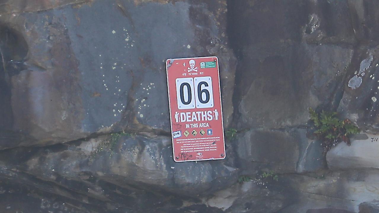 A sign at the north end of the beach advises six deaths have accrued here. Picture: John Grainger