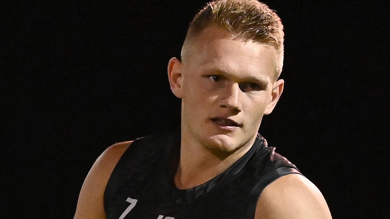 Adam Treloar appears to have a decision to make.