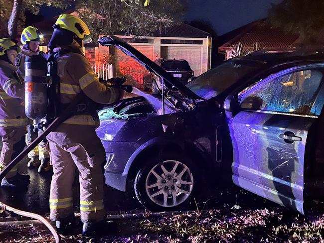 Firefighters attend to Gretta's car shortly after the attack.