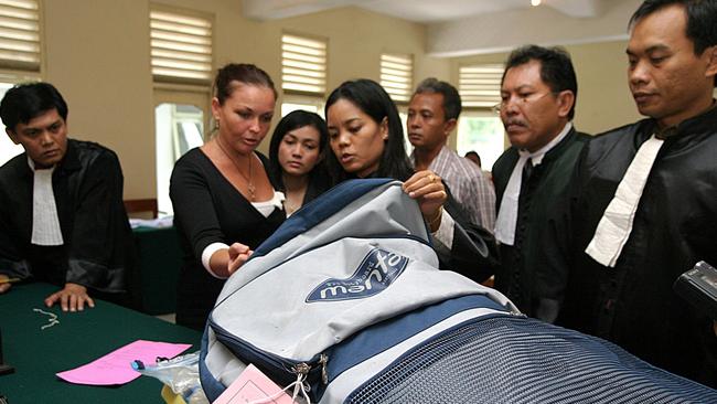 Schapelle Corby checks the evidence in front of the Judge during the trial at Denpasar District Court in Bali, Monday, February. 3.