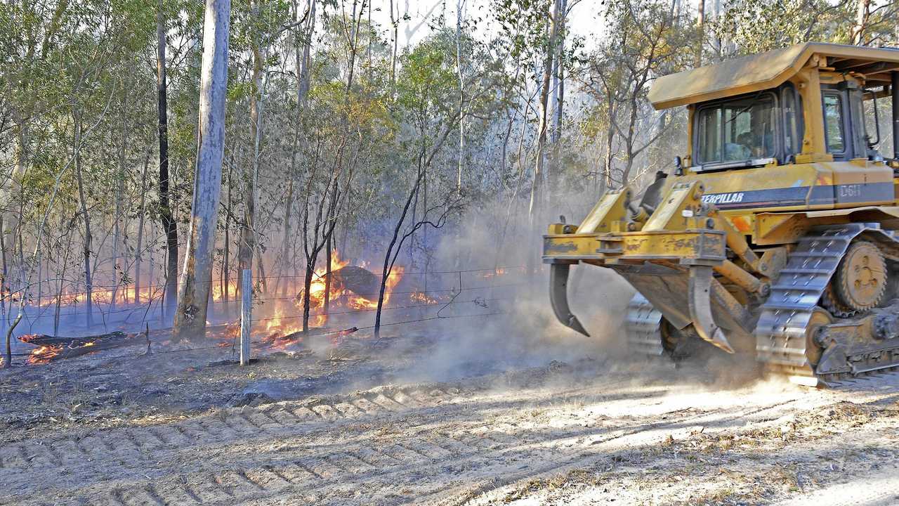 A bulldozer hurries to reinforce containment lines of an out of control bushfire at Whiteman Creek west of Grafton on Saturday, 10th August, 2019. Picture: Bill North