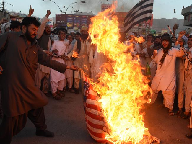 Pakistani Sunni Muslim supporters of hard line pro-Taliban party Jamiat Ulema-i-Islam-Nazaryati (JUI-N) torch a US flag during a protest in Quetta, against a US drone strike in Pakistan's southwestern province Balochistan in which killed Afghan Taliban leader Mullah Akhtar Mansour. Picture: AFP