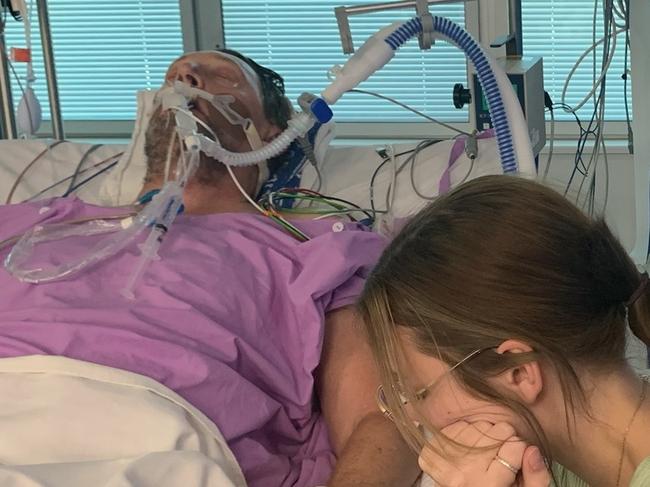 Maddie Roscoe watches over her dad Chris Roscoe in hospital. Photo: supplied