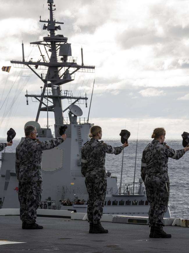 HMAS Adelaide crew cheer HMAS Sydney off the coast of Sydney. Picture: Supplied