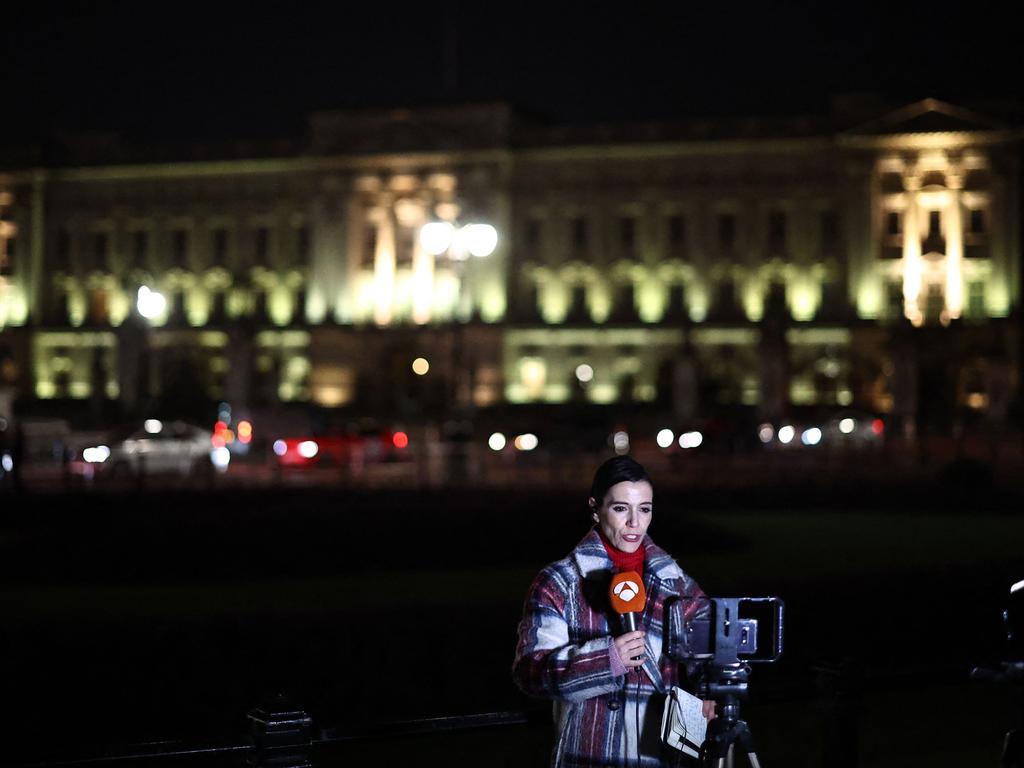 A broadcast journalist reports from outside Buckingham Palace on March 22. Picture: Henry Nicholls / AFP