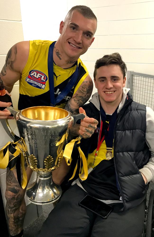 Dustin Martin with Will Murray in the Richmond rooms after the 2017 Grand Final.