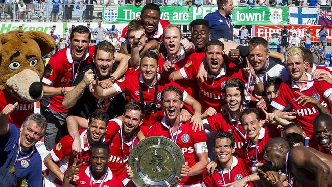 PSV Eindhoven players celebrate with the Dutch eredivisie trophy.