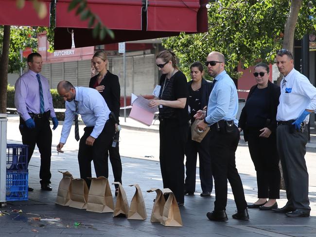 Detectives collect evidence at the murder scene today. Picture: John Grainger